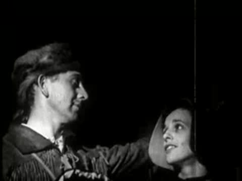 A man and woman looking upward with hopeful expressions.