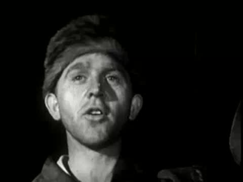 A close-up of a man looking upward with an emotional expression.