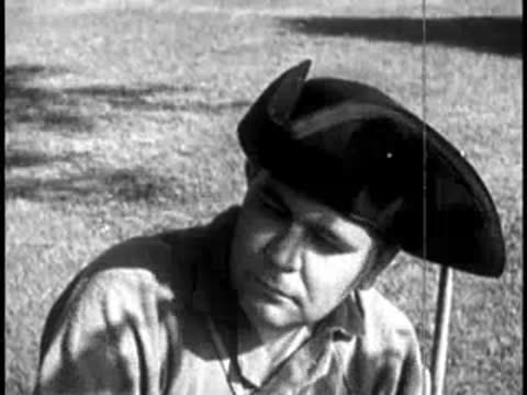 close-up of a man wearing a tricorn hat looking thoughtful outdoors