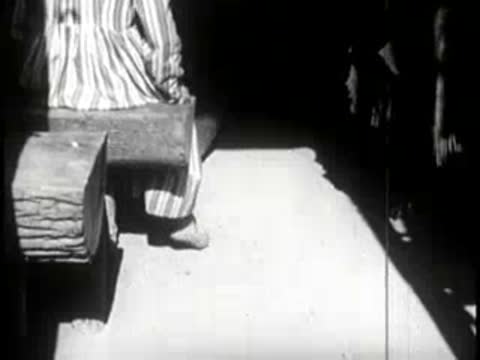 Interior wooden floor with a cut log stool and foot traffic
