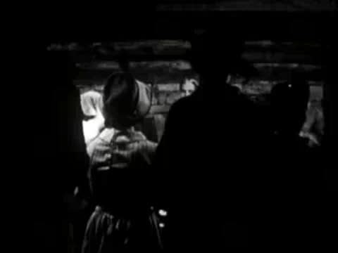 silhouettes of people indoors in dim lighting, period clothing