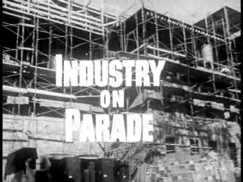 Construction site with scaffolding and overlaid animated show title, 1950s documentary
