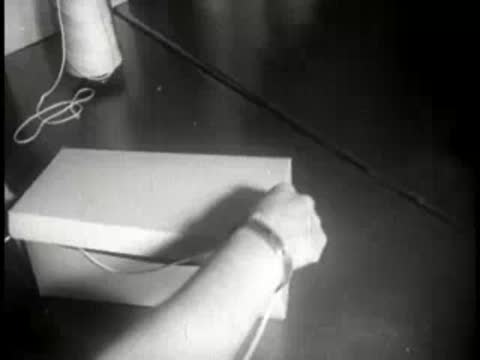 hands wrapping and boxing baked pies in paper packaging