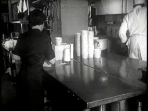 staff member preparing and packaging food items in the kitchen