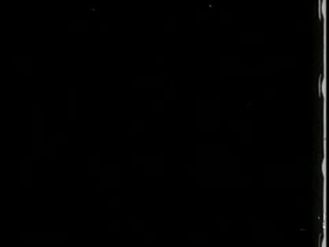 black screen with minimal light speckles or film grain artifacts