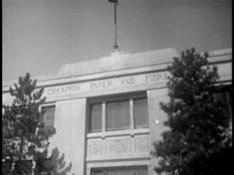 Exterior view of Champion Paper and Fibre company entrance with trees, day