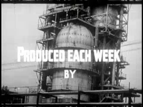 Large industrial storage tanks surrounded by scaffolding, 1950s public domain video