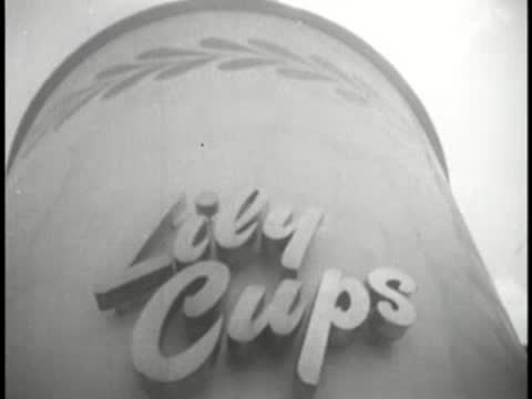Close-up of the "Lily Cups" logo on the side of a large cup structure.
