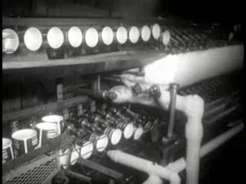 Machinery forming and shaping paper cups in a manufacturing plant.