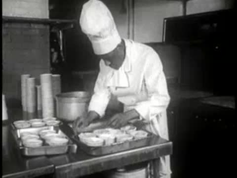 chef loading a tray of unbaked pies into an oven
