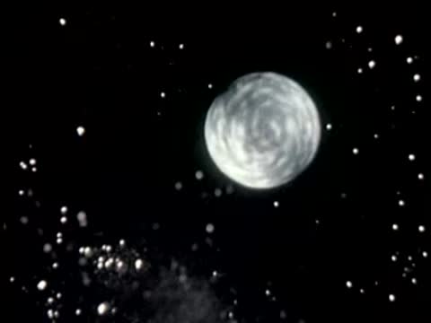 Animation of rotating moon in starry night sky.