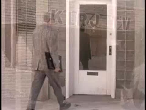 A man walks out of the KLRJ TV building entrance, 1950s architecture