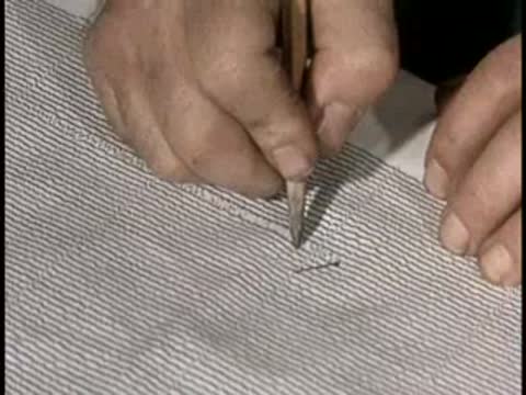 Close-up of a pen drawing lines on a chart, then a man speaking