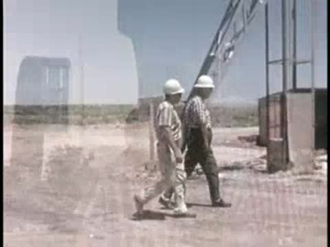 men walking outside public health department and near a dump truck