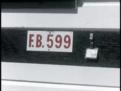 sign on building reads "E.B. 599" with small light fixture