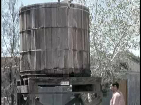 large wooden water tank on support structure outdoors