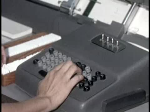 hands operating mechanical calculator machine indoors