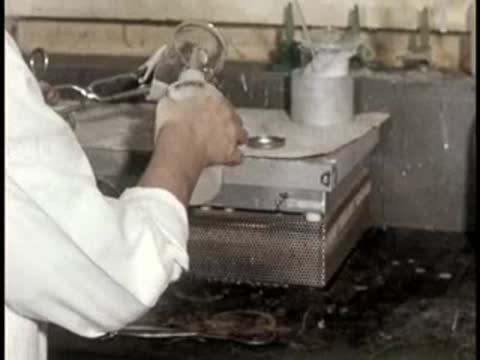 worker using laboratory glassware and liquid dispenser apparatus