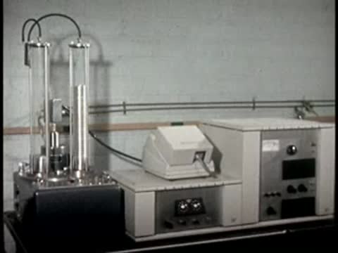 A laboratory setup with two vertical glass columns filled with discs and electronic equipment.