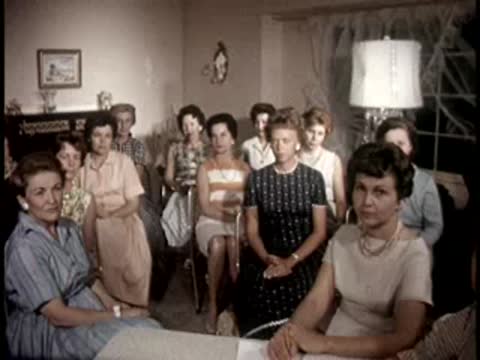 Group of women seated together in a living room, 1950s home setting