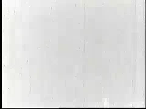 Close-up of a human hand holding two small eggs, vintage documentary footage