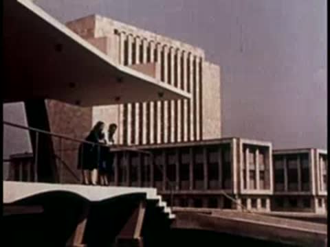Modern concrete buildings with geometric balconies and overhangs.
