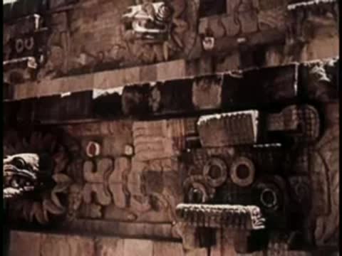 Close-up of intricately carved stone reliefs on an ancient wall.