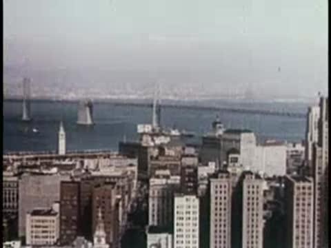 A city skyline view from a high vantage point, mid-century era.